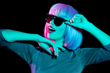 Image showing happy woman in pink wig and sunglasses dancing