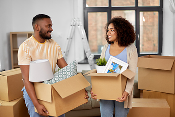 Image showing happy couple with boxes moving to new home