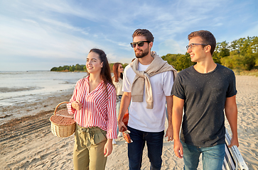 Image showing happy friends walking along summer beach