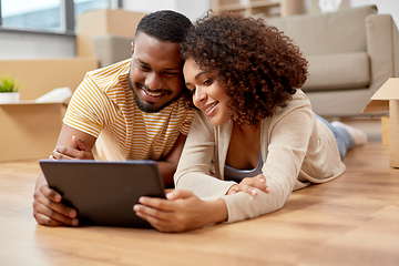 Image showing happy couple with tablet pc computer at new home