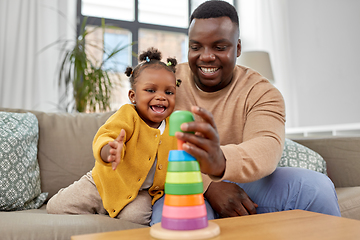 Image showing african family playing with baby daughter at home