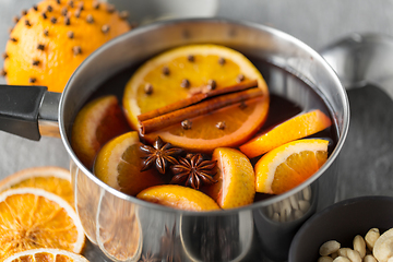 Image showing pot with hot mulled wine, orange slices and spices