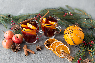 Image showing glass of hot mulled wine, cookies, apples and fir