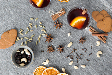 Image showing hot mulled wine, orange slices, raisins and spices