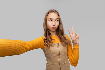 Image showing funny teenage girl taking selfie and making faces