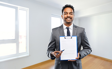 Image showing indian man realtor with contract at new apartment