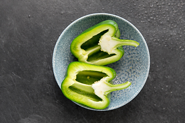 Image showing cut green pepper in bowl on slate stone background