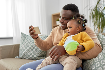 Image showing happy father with baby taking selfie at home