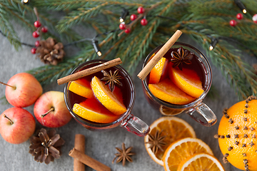 Image showing glass of hot mulled wine, cookies, apples and fir