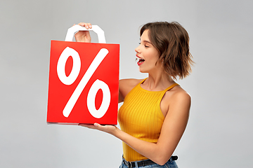 Image showing happy young woman with shopping bag on sale