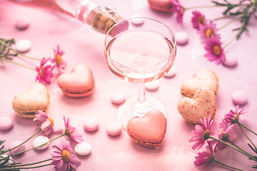 Image showing Happy Mothers Day - sweet macarons in heart shape and glass of rose sparkling wine