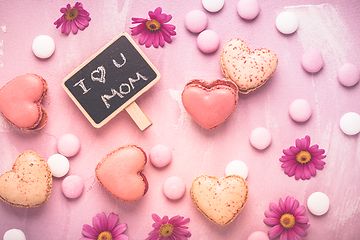 Image showing Happy Mothers Day - sweet macarons in heart shape with flowers