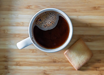 Image showing cup of black coffee and cookie