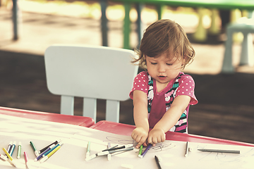 Image showing little girl drawing a colorful pictures