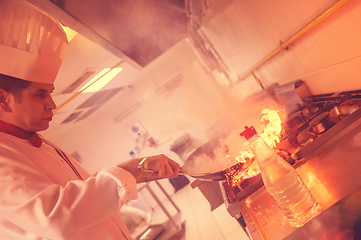 Image showing Chef doing flambe on food