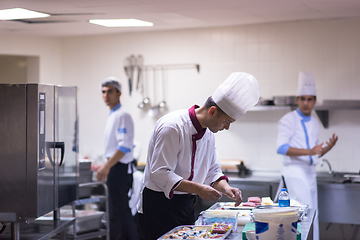 Image showing team cooks and chefs preparing meals