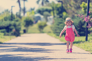 Image showing little girl runing in the summer Park