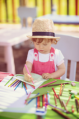 Image showing little girl drawing a colorful pictures