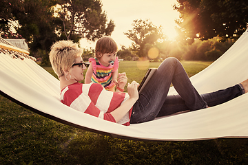 Image showing mom and a little daughter relaxing in a hammock