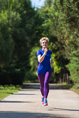 Image showing young female runner training for marathon