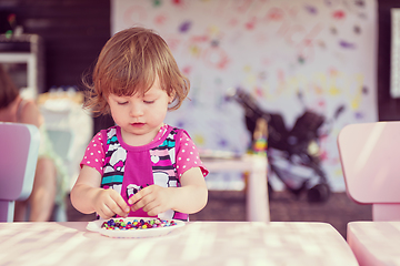 Image showing little girl drawing a colorful pictures