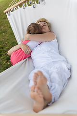 Image showing mother and a little daughter relaxing in a hammock