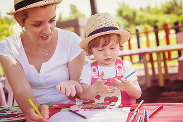 Image showing mom and little daughter drawing a colorful pictures