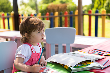 Image showing little girl drawing a colorful pictures