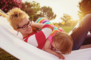 Image showing mom and a little daughter relaxing in a hammock