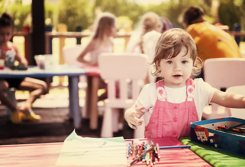 Image showing little girl drawing a colorful pictures