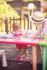 Image showing mom and little daughter drawing a colorful pictures