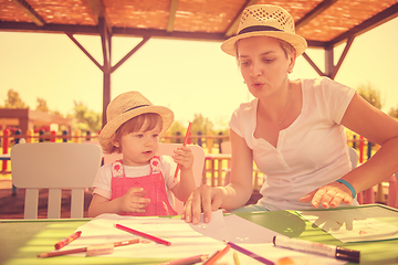 Image showing mom and little daughter drawing a colorful pictures