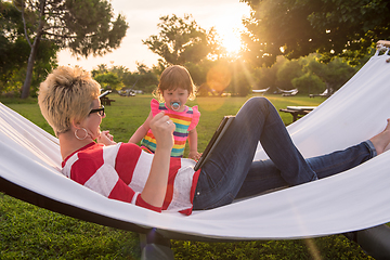 Image showing mom and a little daughter relaxing in a hammock