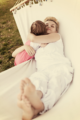 Image showing mother and a little daughter relaxing in a hammock