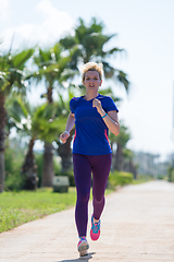 Image showing young female runner training for marathon