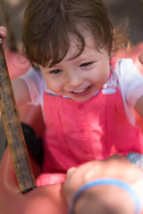 Image showing little girl swinging  on a playground