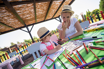 Image showing mom and little daughter drawing a colorful pictures