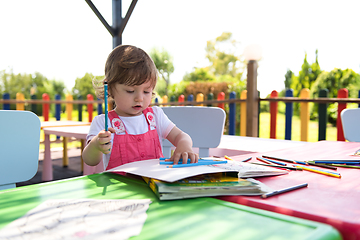 Image showing little girl drawing a colorful pictures