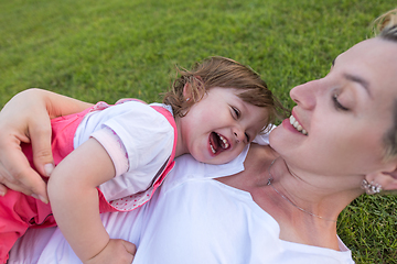 Image showing mother and little daughter playing at backyard