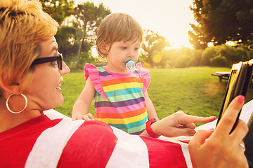 Image showing mom and a little daughter relaxing in a hammock