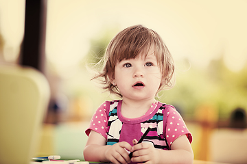 Image showing little girl drawing a colorful pictures