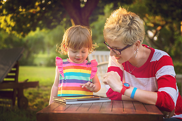 Image showing mom and her little daughter using tablet computer