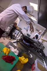 Image showing chef preparing food, frying in wok pan