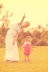 Image showing mother and little daughter playing at backyard