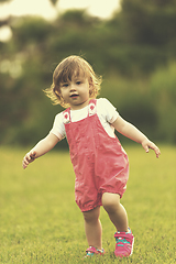 Image showing little girl spending time at backyard