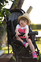 Image showing baby girl sitting in the baby stroller