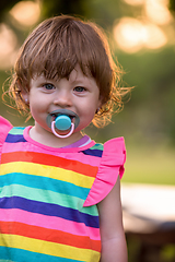 Image showing little girl spending time at backyard