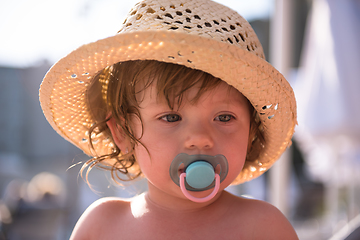 Image showing tired little girl resting on sunbed