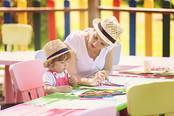 Image showing mom and little daughter drawing a colorful pictures