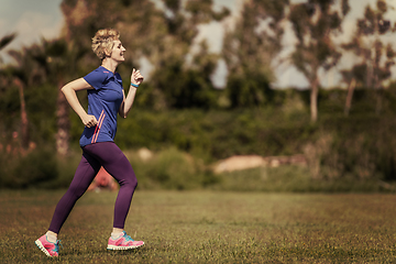 Image showing young female runner training for marathon